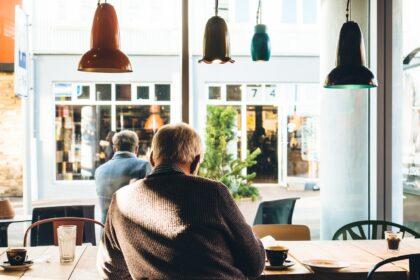 man in chair with table beside coffee