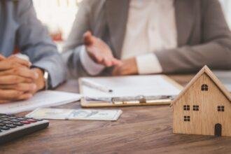 House signers signing signature loan document to home ownership with real estate agents ownership