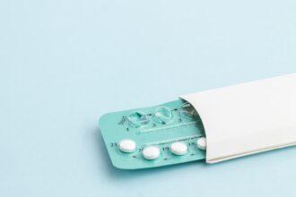 Contraception pills on blue background. Birth control